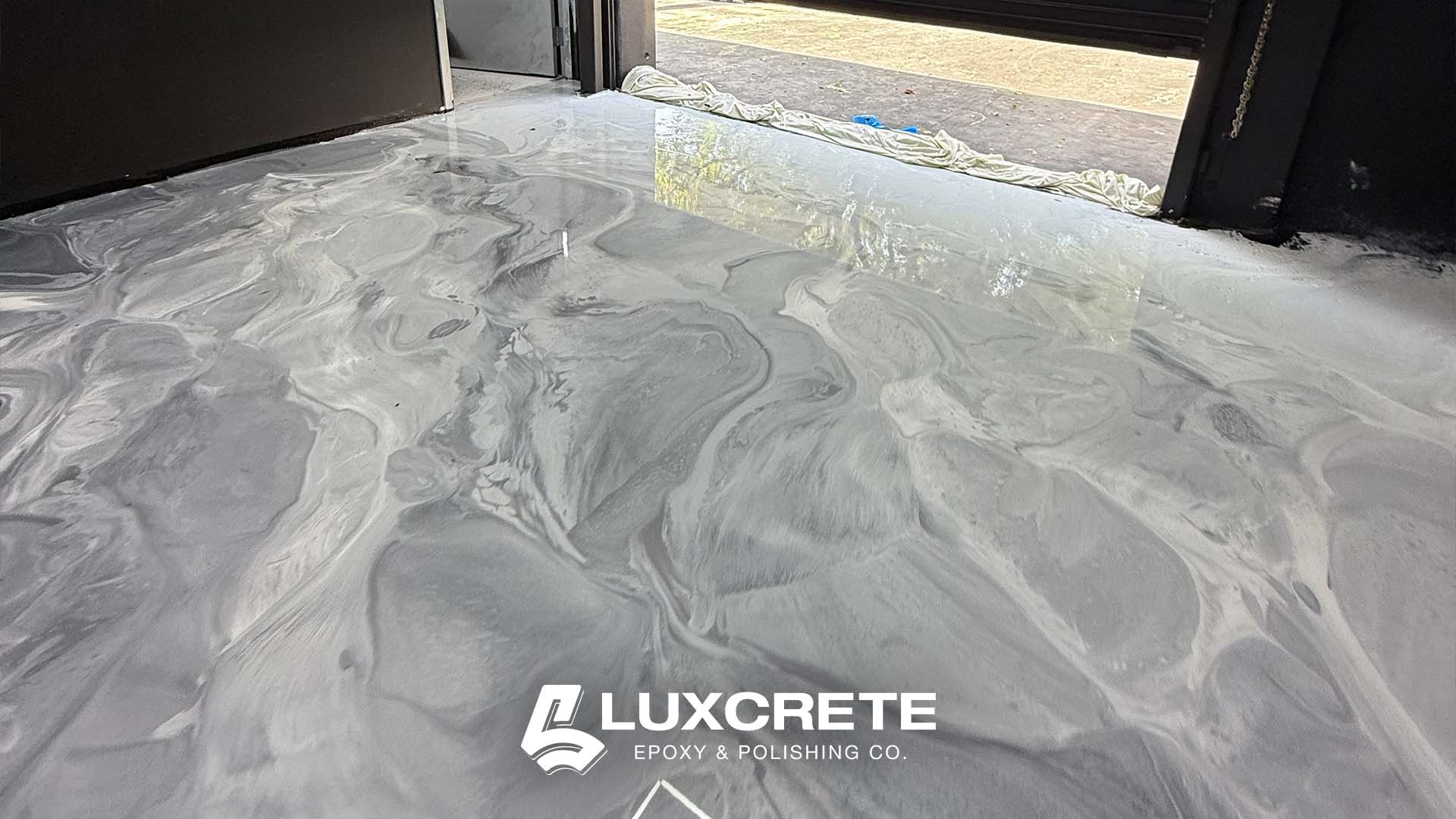 An awesome faux-marble metallic epoxy floor installed in an industrial automotive shop by LuxCrete Epoxy & Polishing of Wichita, KS